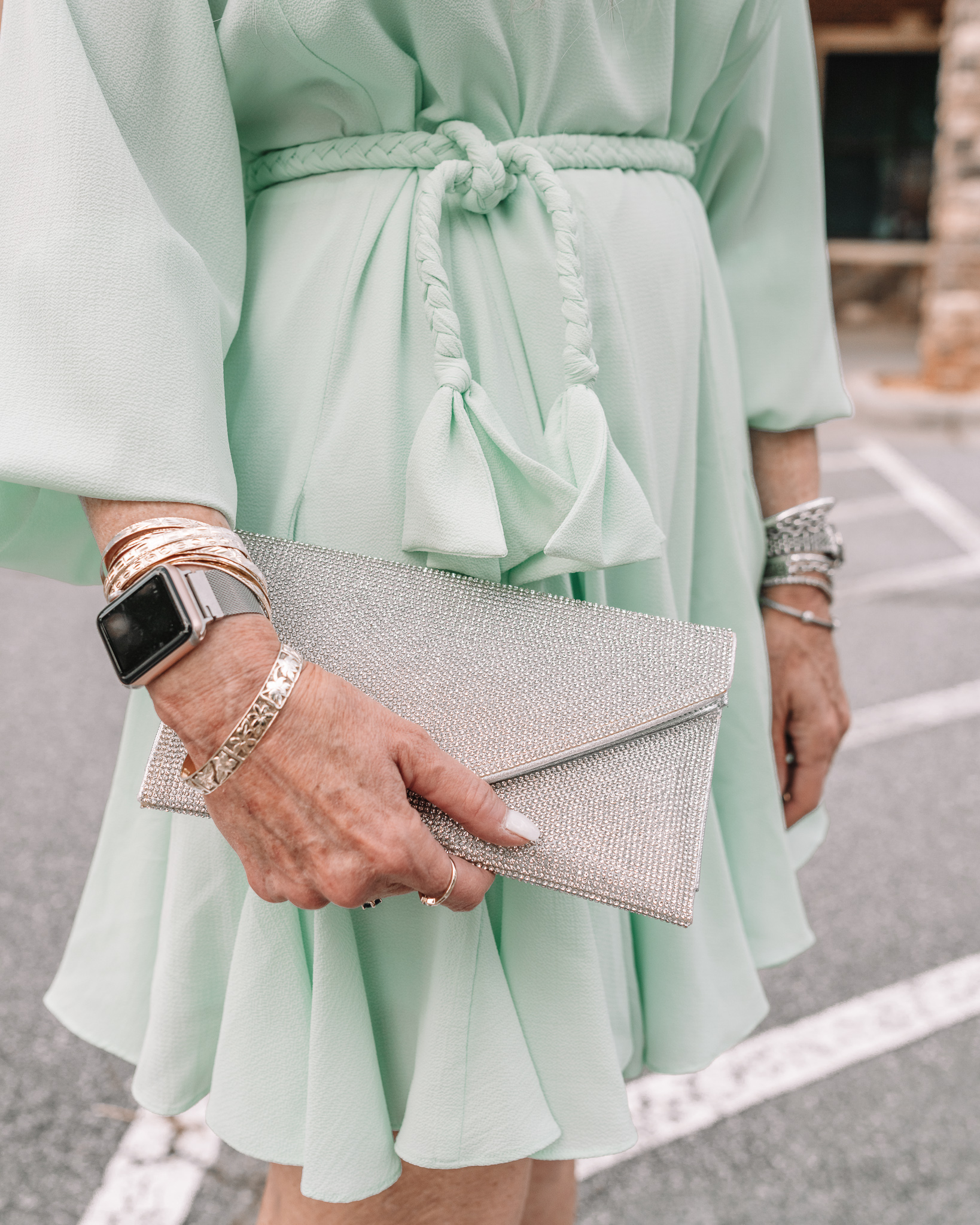 lisa in a mint green above the knee formal wedding guest dress and silver pumps
