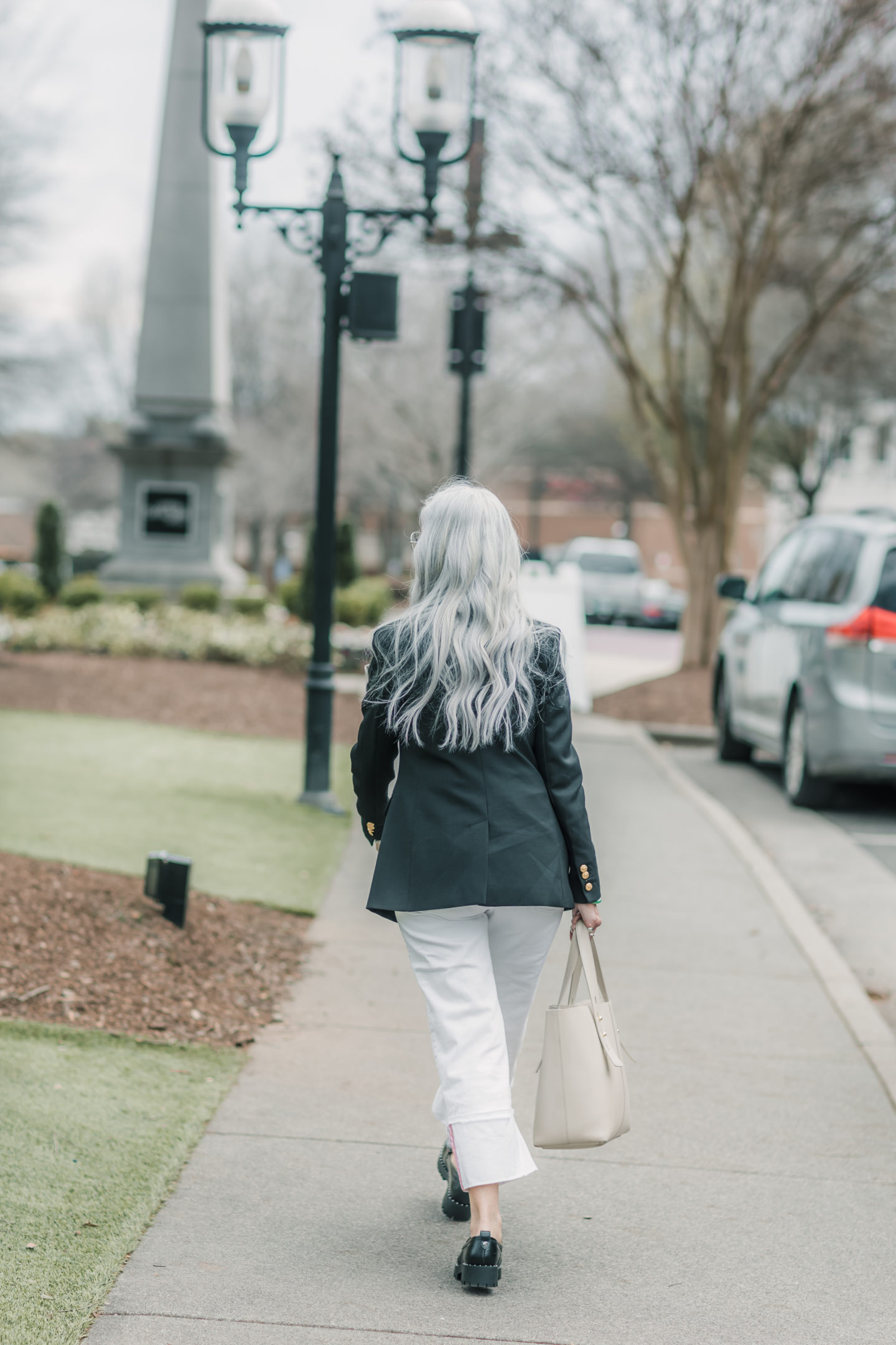 long silver hair black jacket and white trousers