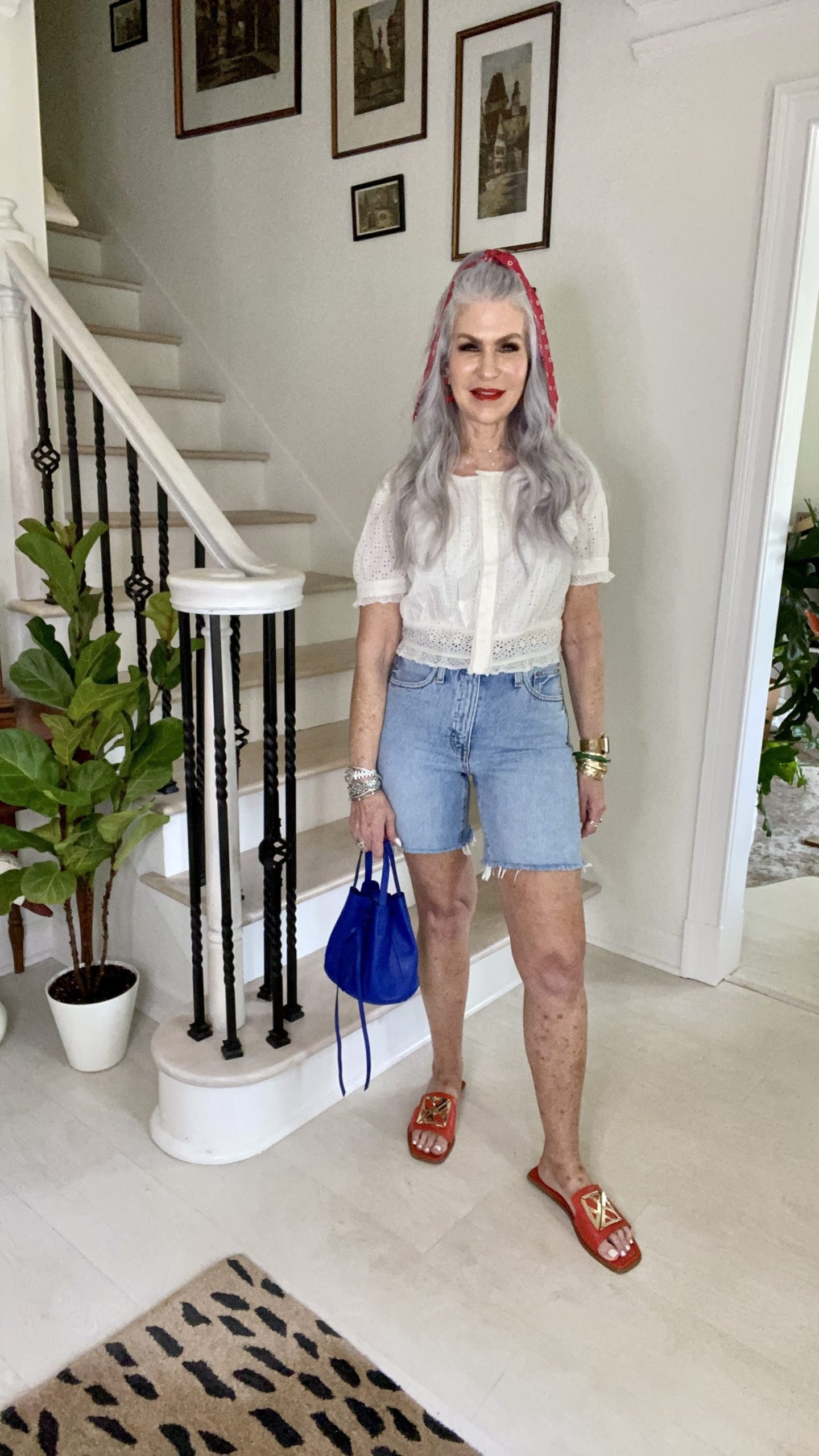 lady wearing cut off denim shorts with white shirt