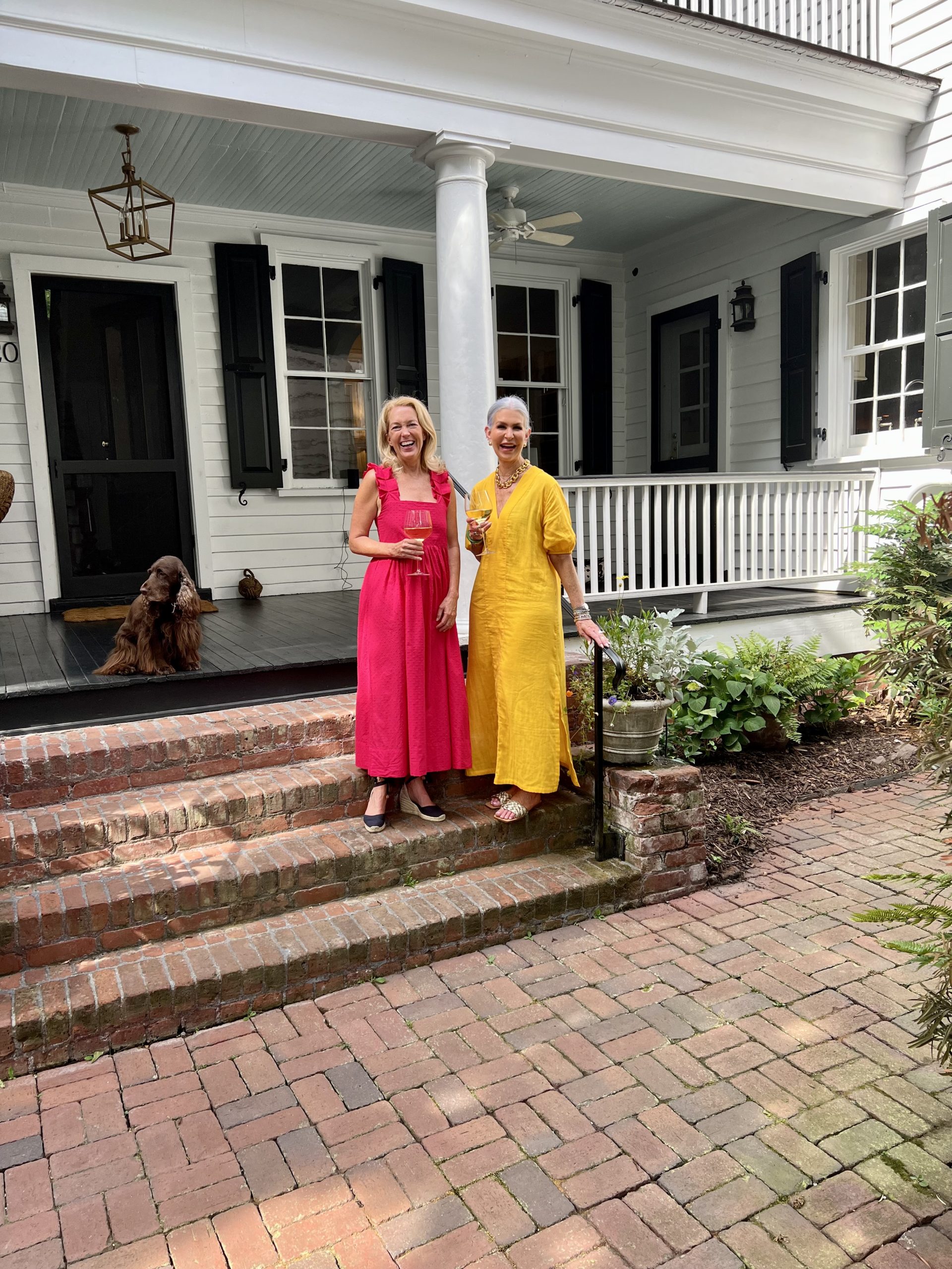 Ladies in front of house in dresses