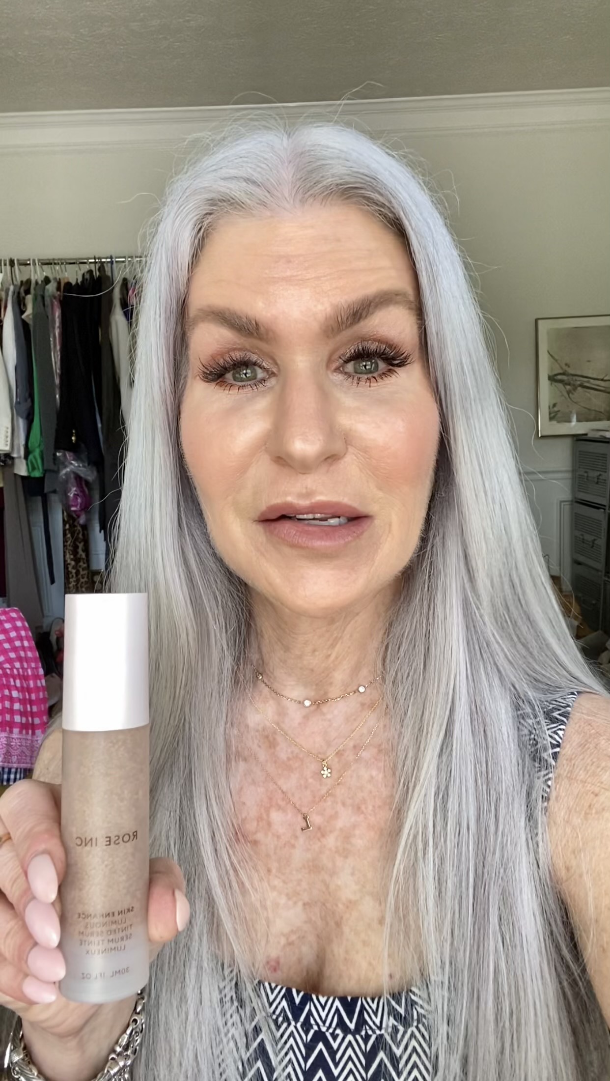 Silver Hair lady holding Rose Inc Makeup