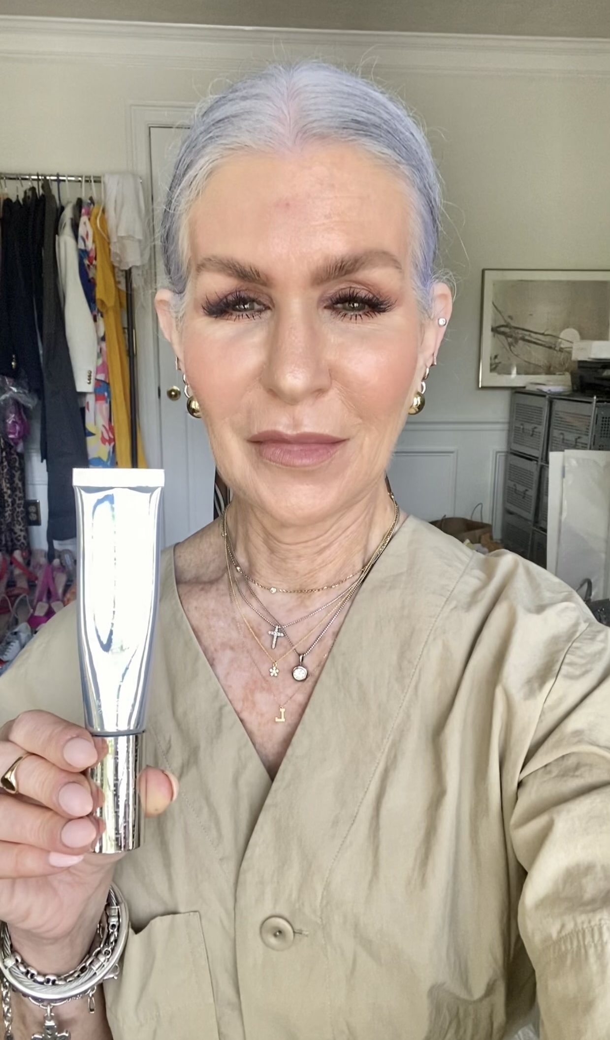 Silver Hair lady holding trinny london foundation