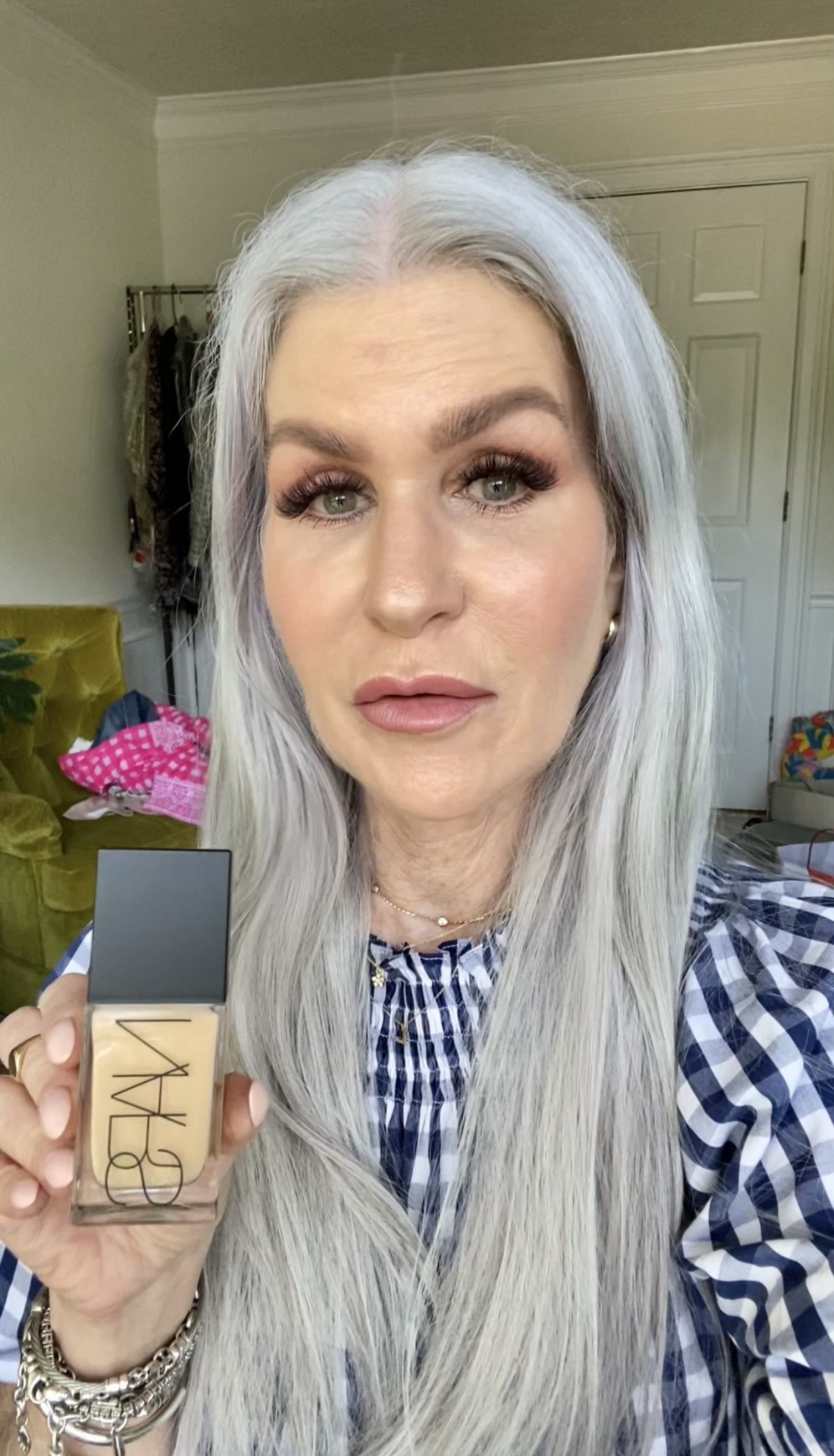 Silver hair lady holding Nars foundation