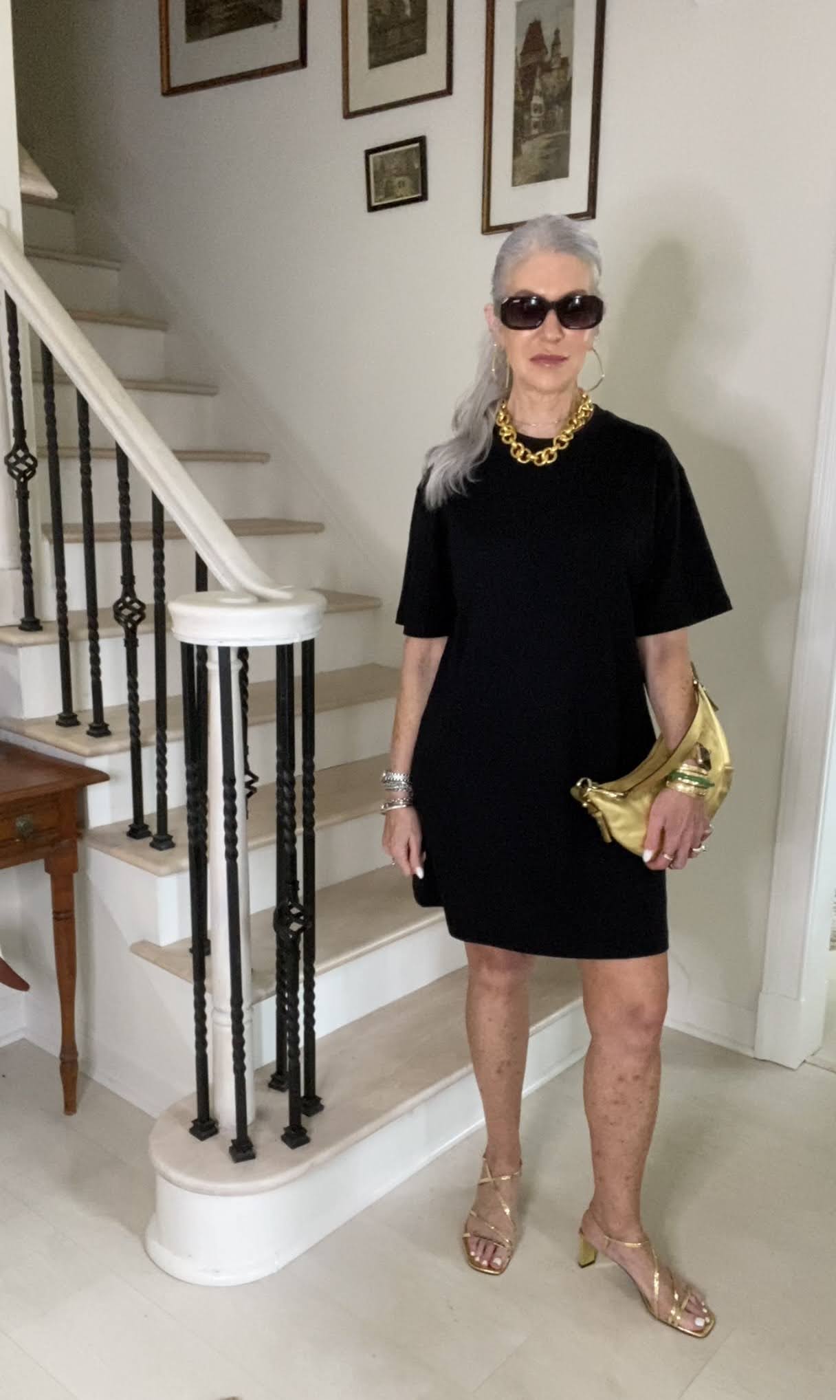 lady wearing black dress with gold accessories