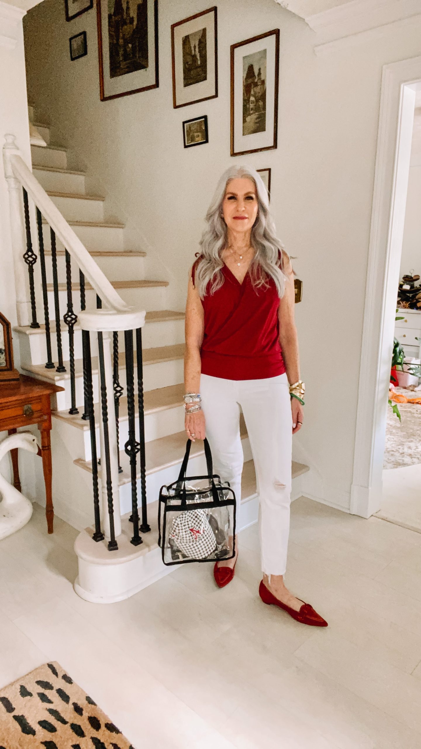 silver hair lady wearing white pants and maroon top