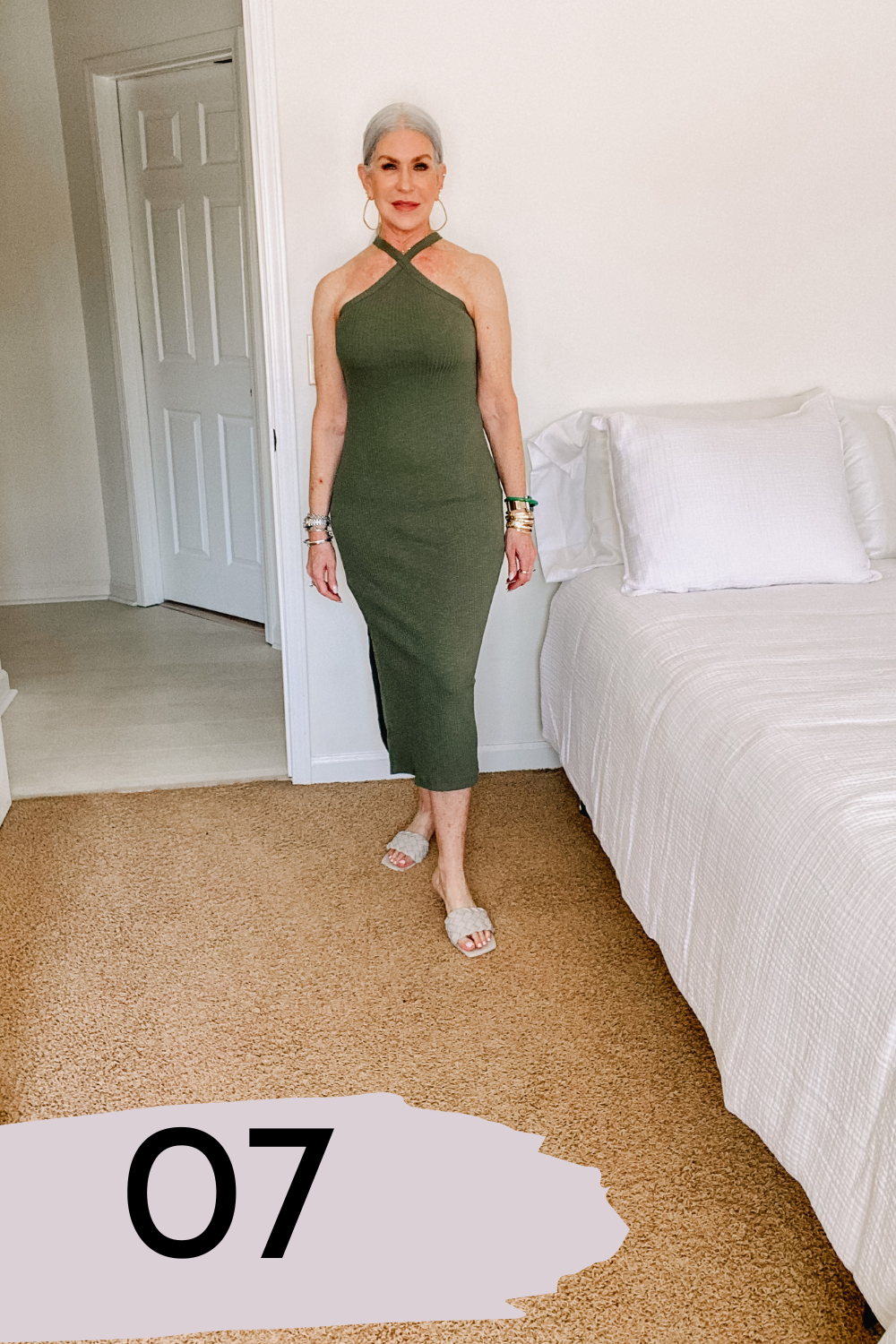 silver hair lady wearing fitted olive green dress