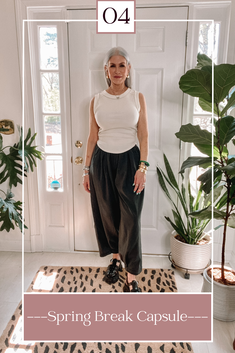silver hair lady wearing black pants and white top
