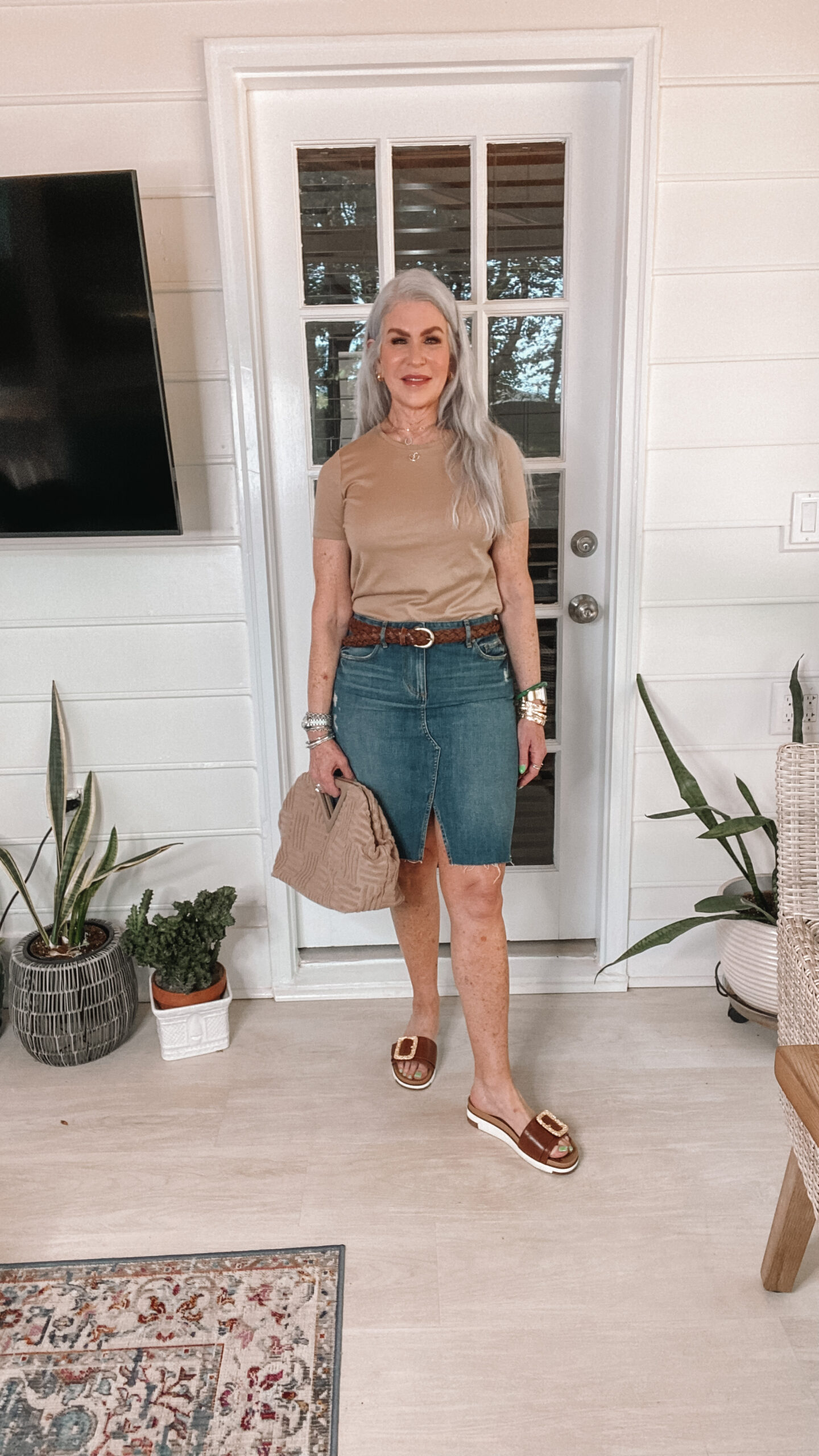 middle age woman wearing camel tee and denim skirt with braided belt