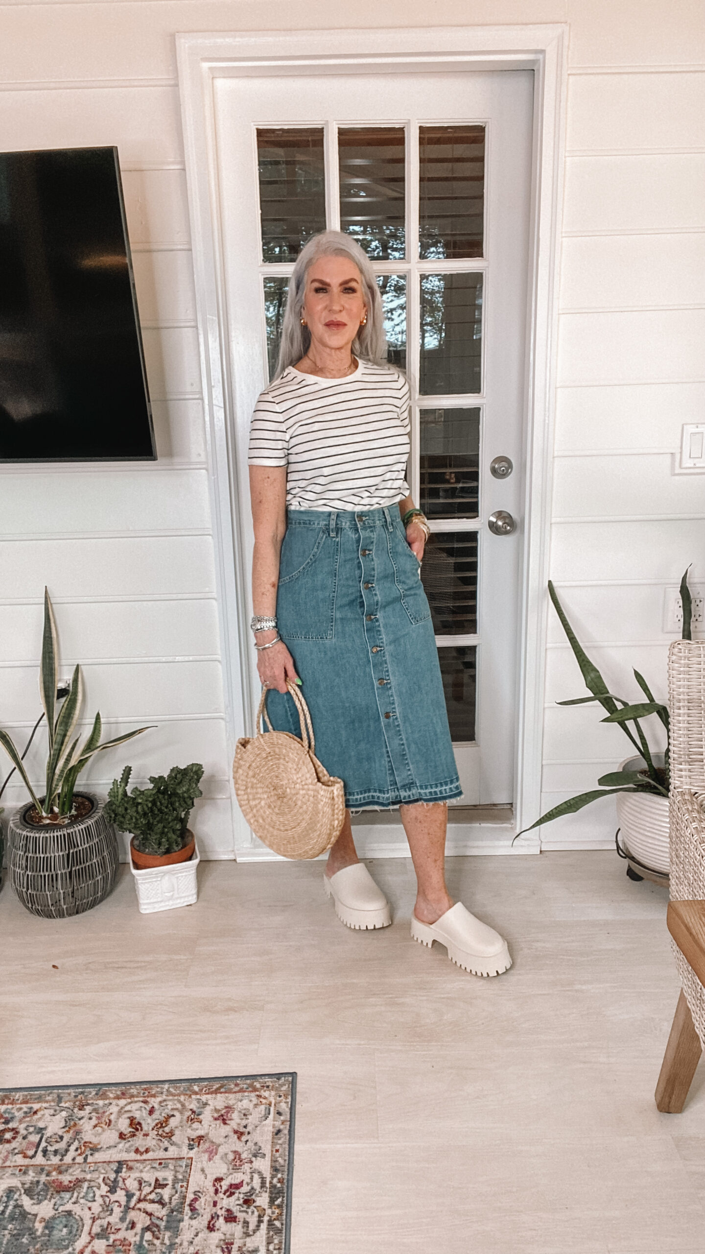 middle age woman wearing striped tee with a-line denim skirt